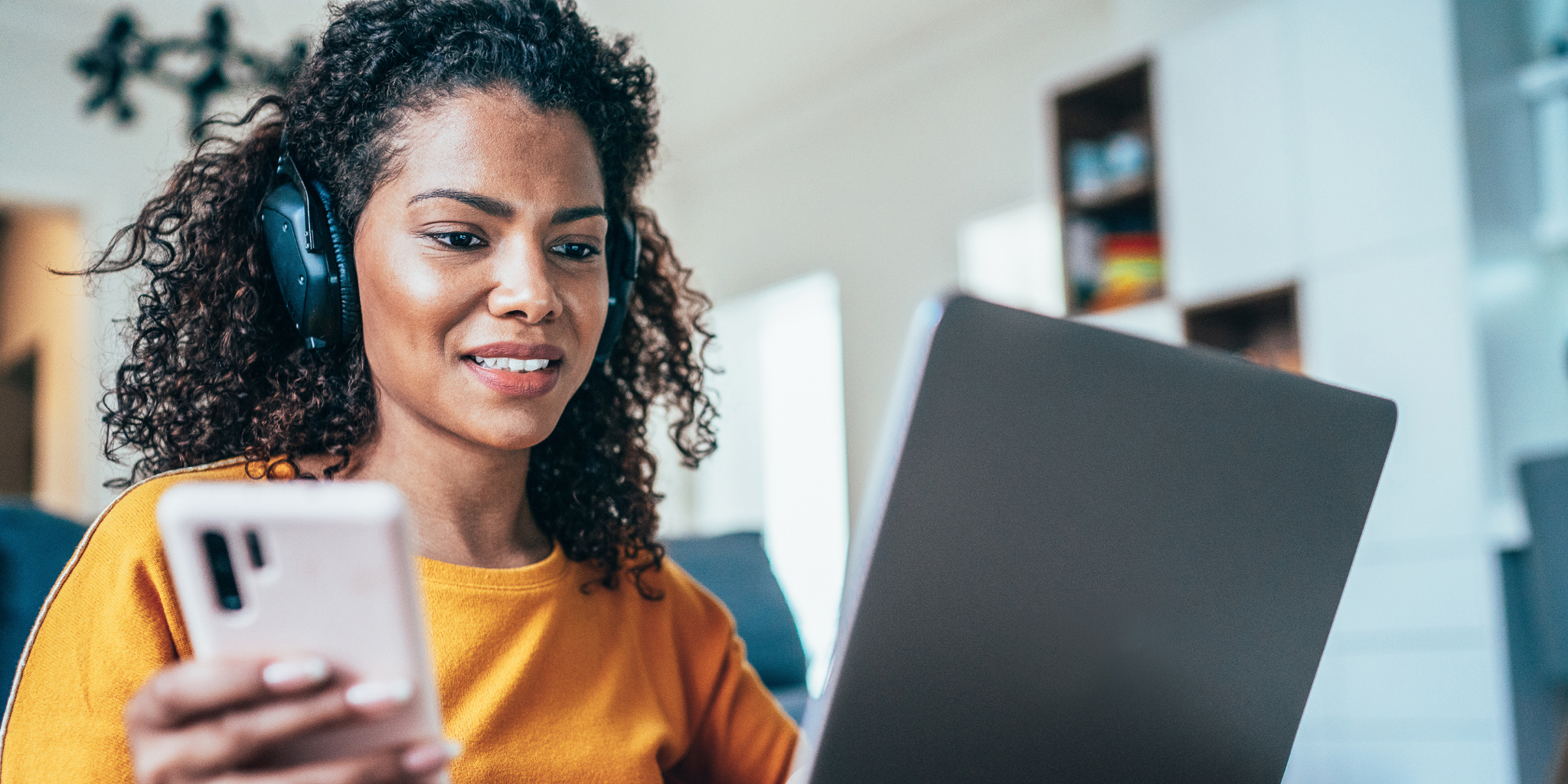 woman in yellow shirt working from home on computer