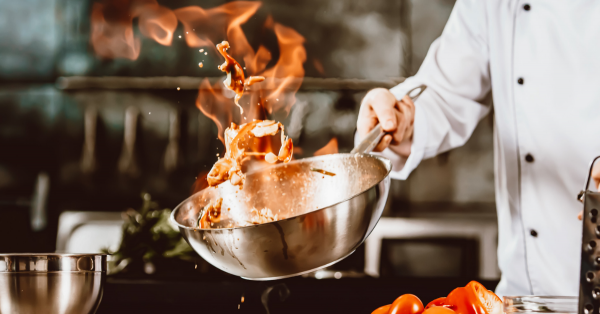 Chef tossing a flaming pan - JOEY Restaurant Group - Coaching Case Study Image - ICF Prism Award & High-Performance Coaching Culture