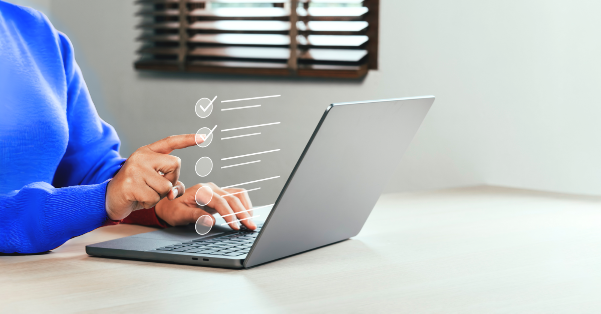 woman in blue sweater completing an online performance evaluation.